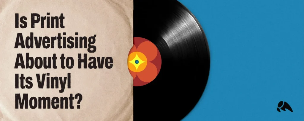 Featured blog header graphic against a bright blue background, featuring a black vinyl record sliding out of a paper sleeve that reads: "Is Print Advertising About to Have Its Vinyl Moment?"